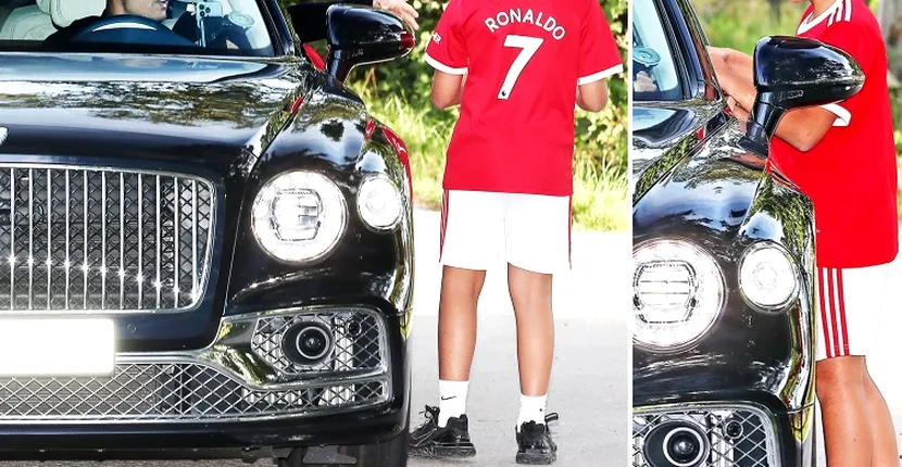 Cristiano Ronaldo semnează tricoul unui băiat la sosirea la antrenamentul de la Manchester United
