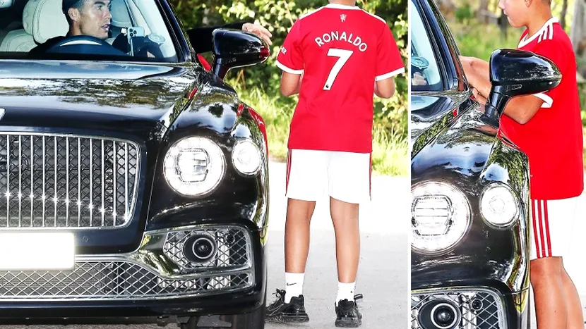 Cristiano Ronaldo semnează tricoul unui băiat la sosirea la antrenamentul de la Manchester United